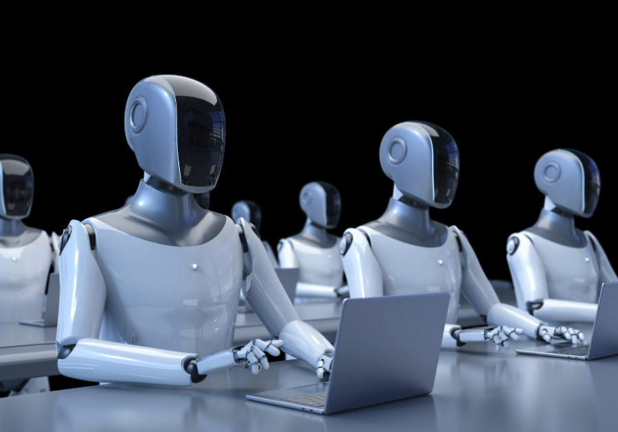 a group of robots sat around a desk using laptops representing Agentic AI